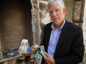 Dr. Eibner holds the shards of a statue of the Virgin Mary, destroyed by extremists who attacked a Christian school in Egypt.
