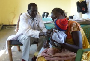 Dr. Luka, CSI's field physician, examines a baby in his new clinic.
